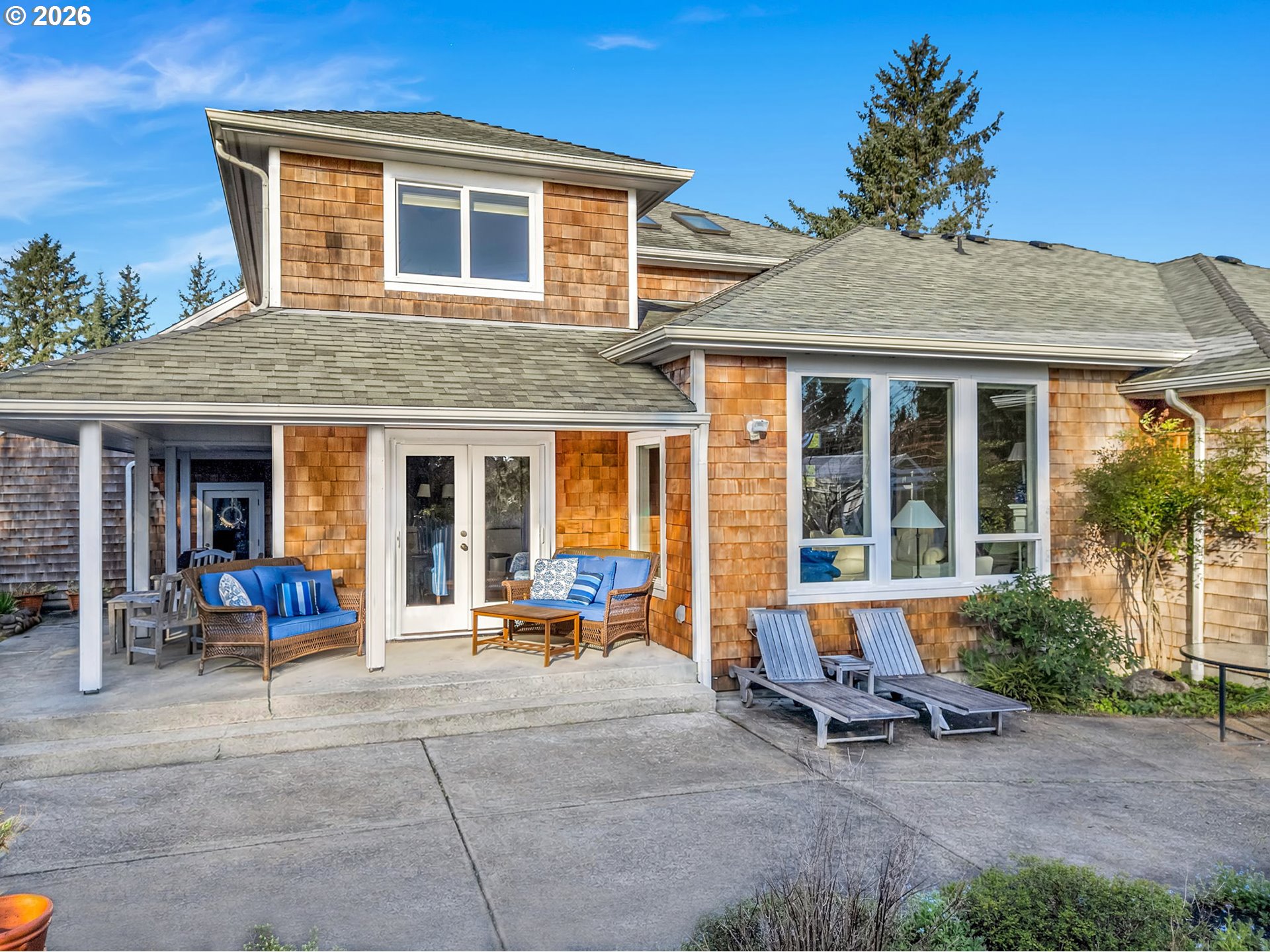 2537 Pine Ridge Drive Gearhart, OR 97138 - Photo 4 of 35 a view of a brick house with chairs and table in a patio