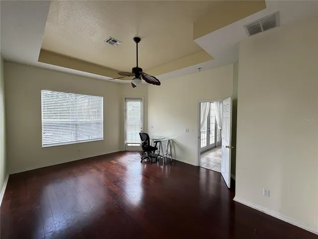 a view of a workspace with furniture and a window