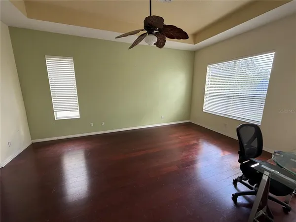 a bedroom with a bed and a potted plant