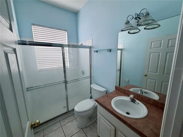 a bedroom with bed and a potted plant