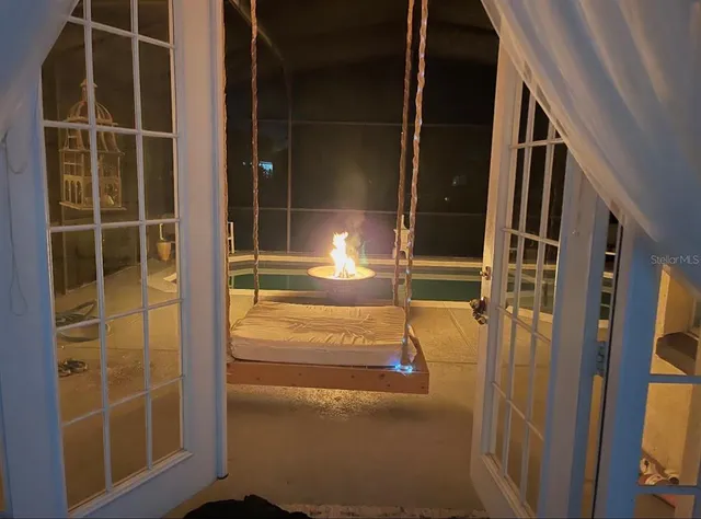 a backyard of a house with barbeque oven table and chairs