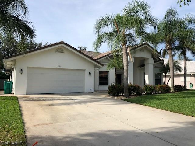 538 Roma Court Naples, FL 34110 - Photo 1 of 19 a view of house with yard and tree in front of it