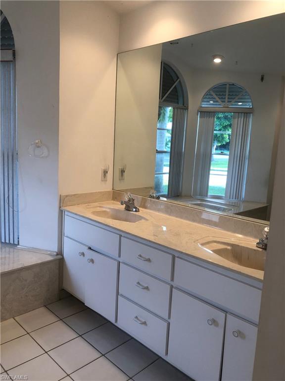 538 Roma Court Naples, FL 34110 - Photo 12 of 19 a bathroom with a sink and a mirror