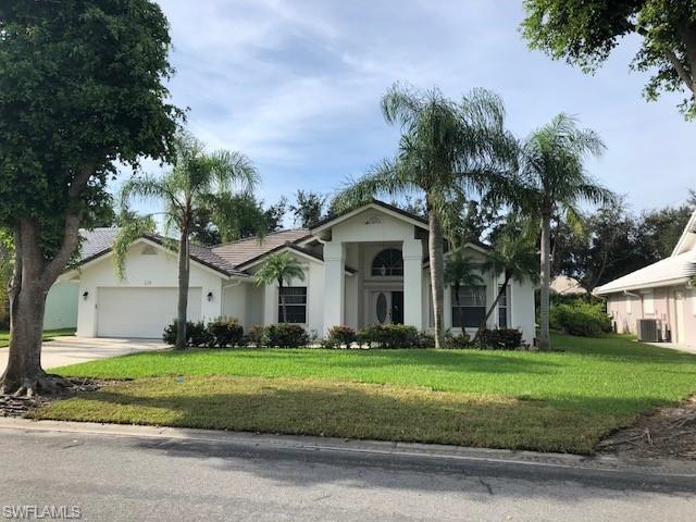 538 Roma Court Naples, FL 34110 - Photo 2 of 19 a front view of a house with a yard
