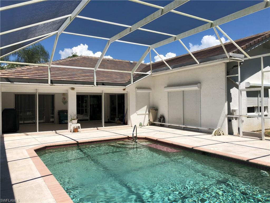 538 Roma Court Naples, FL 34110 - Photo 5 of 19 a backyard of a house with table and chairs