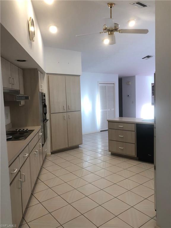 538 Roma Court Naples, FL 34110 - Photo 7 of 19 a kitchen with stainless steel appliances granite countertop a refrigerator and a stove