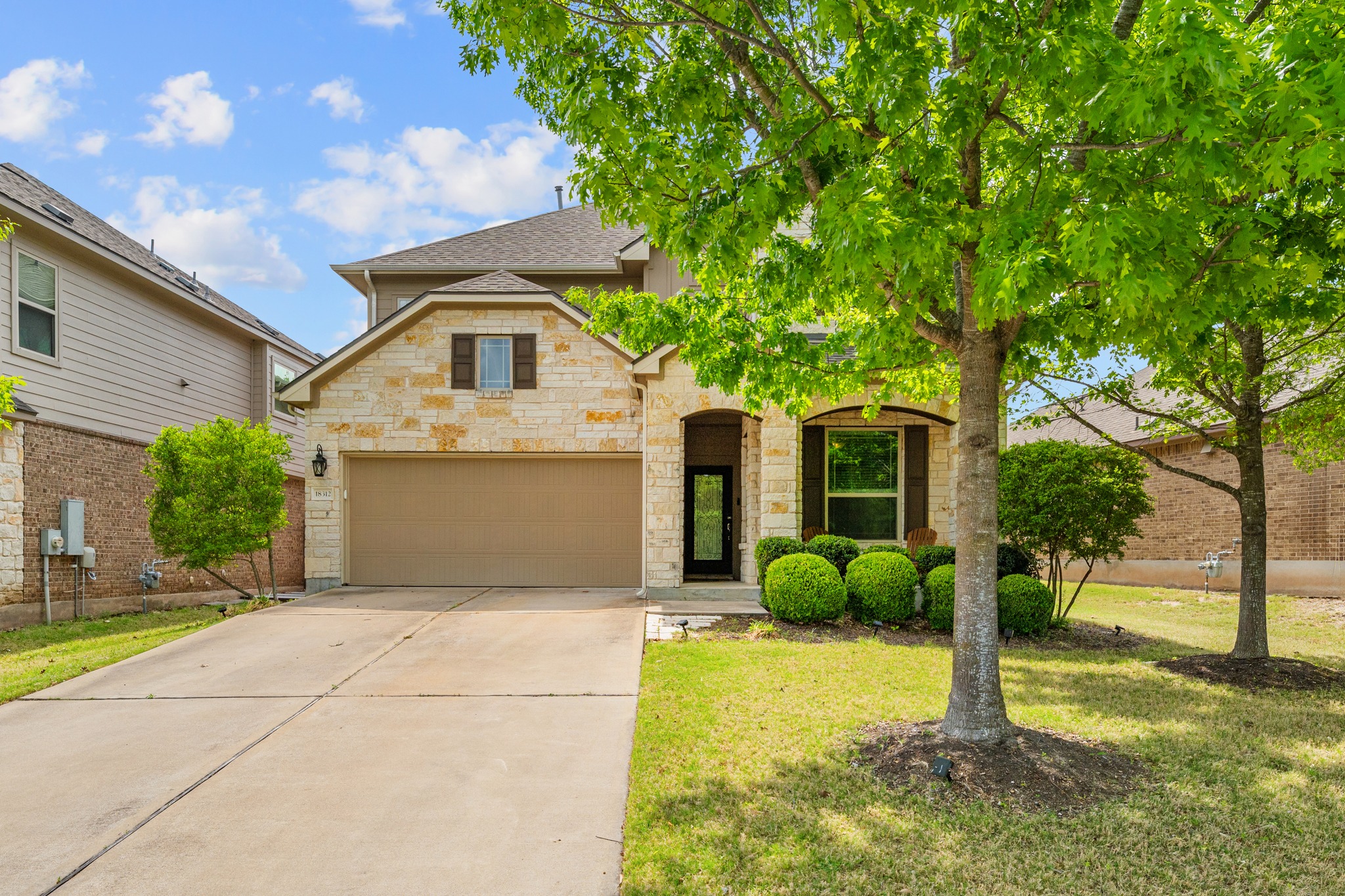 18312 Turning Stream Lane Pflugerville, TX 78660 - Photo 1 of 40 a front view of a house with garden