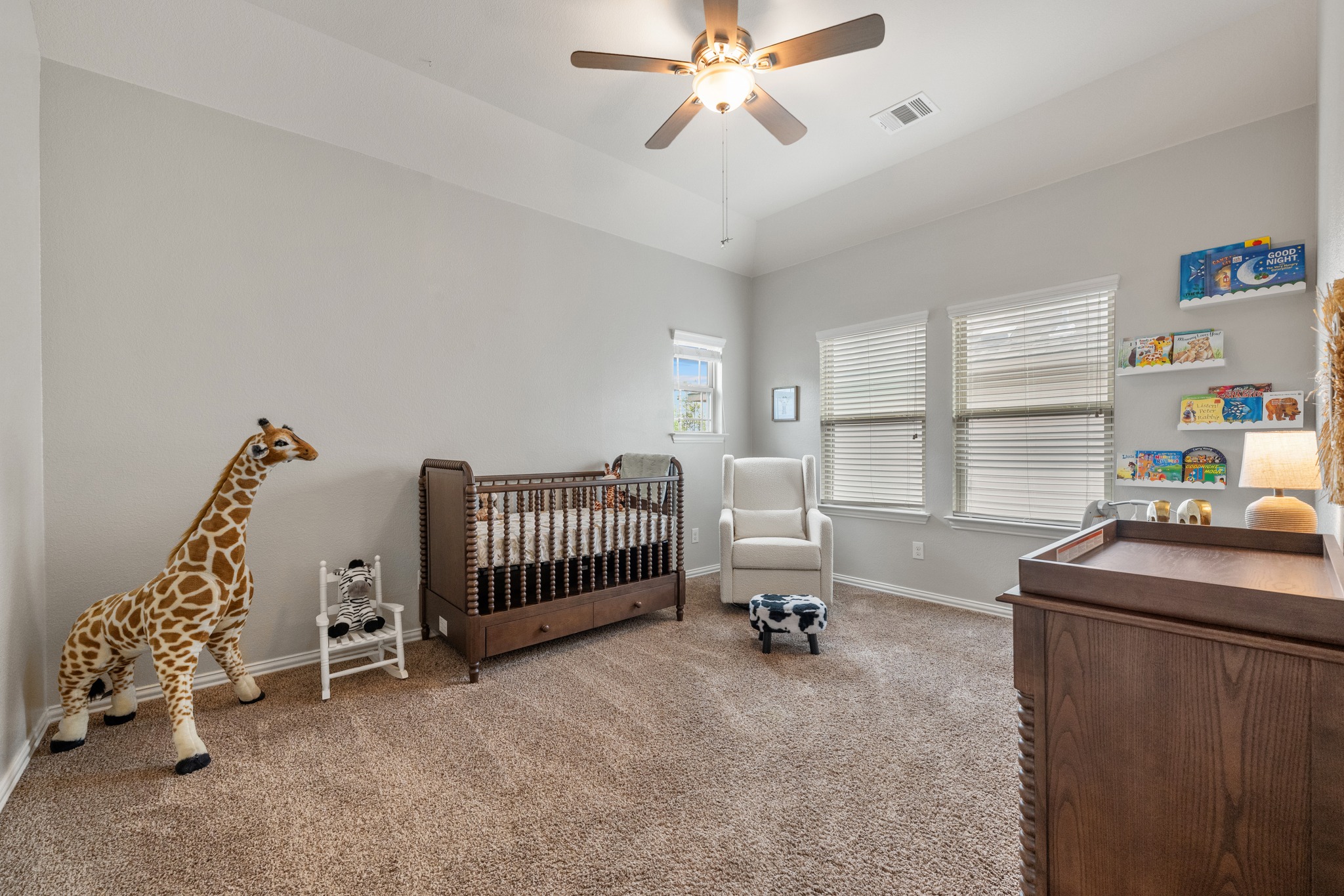 18312 Turning Stream Lane Pflugerville, TX 78660 - Photo 23 of 40 a room with a baby crib furniture a chandelier and a window