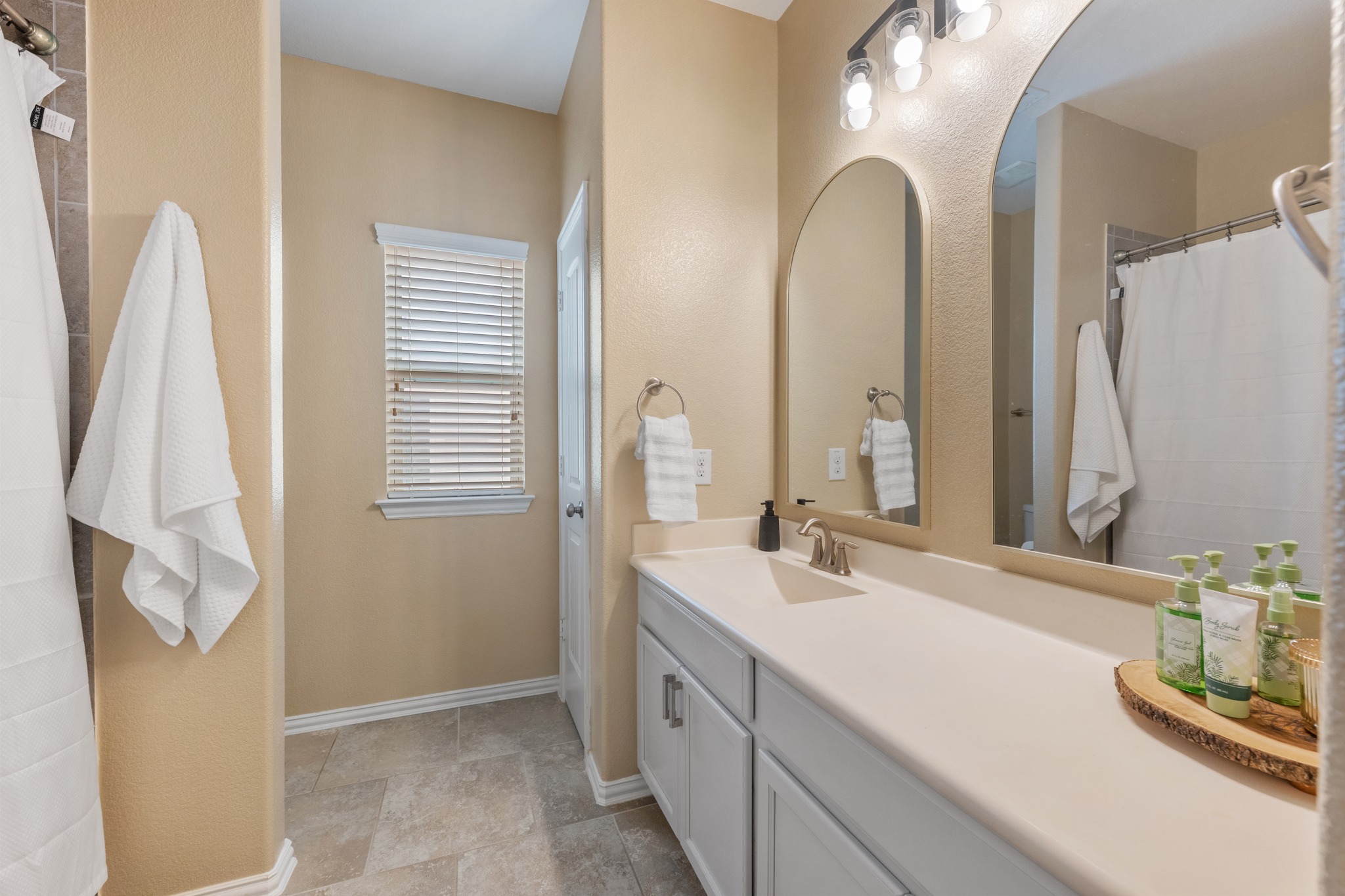 18312 Turning Stream Lane Pflugerville, TX 78660 - Photo 24 of 40 a bathroom with double vanity sink and a mirror
