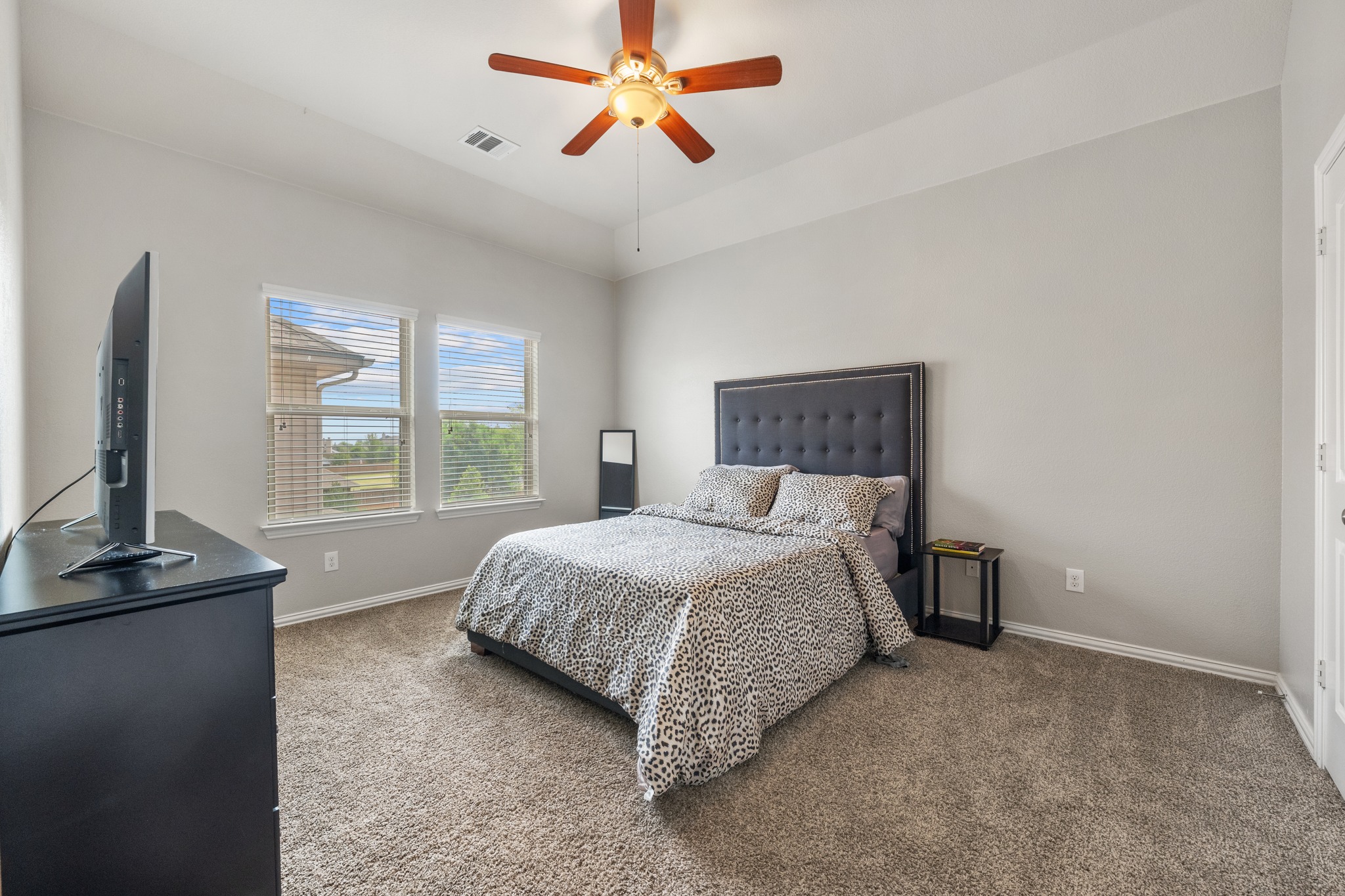 18312 Turning Stream Lane Pflugerville, TX 78660 - Photo 25 of 40 a bedroom with a bed window and flat screen tv