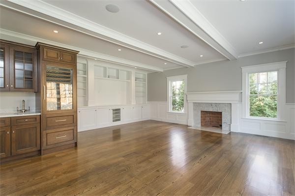 150 Princeton Road Brookline, MA 02467 - Photo 14 of 30 an empty room with wooden floor fireplace and windows