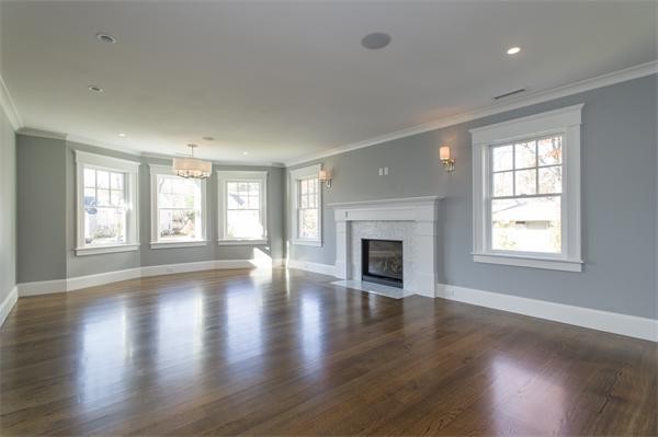 150 Princeton Road Brookline, MA 02467 - Photo 15 of 30 an empty room with wooden floor fireplace and windows