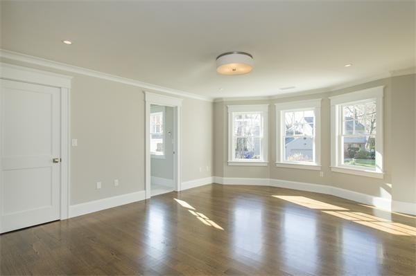 150 Princeton Road Brookline, MA 02467 - Photo 19 of 30 an empty room with wooden floor and windows