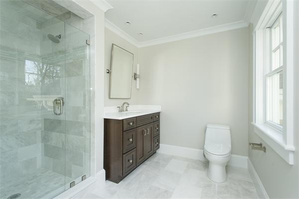 150 Princeton Road Brookline, MA 02467 - Photo 20 of 30 a bathroom with a double vanity sink toilet and shower