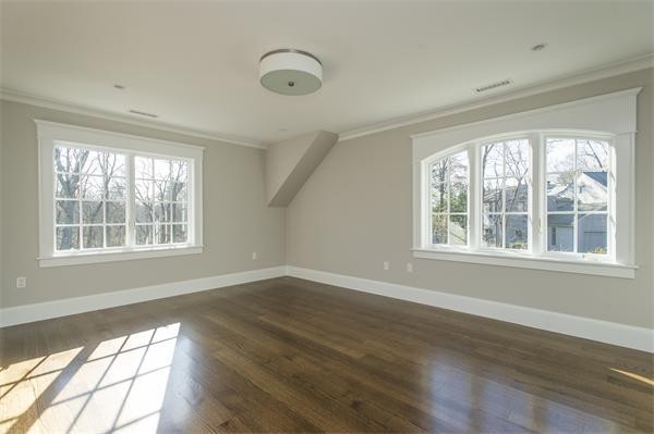 150 Princeton Road Brookline, MA 02467 - Photo 22 of 30 an empty room with wooden floor and windows