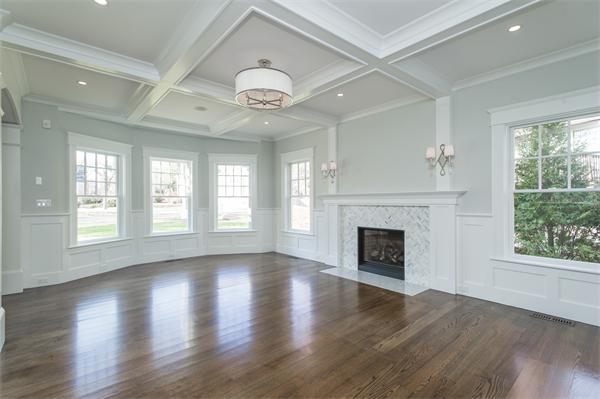 150 Princeton Road Brookline, MA 02467 - Photo 6 of 30 an empty room with wooden floor fireplace and windows