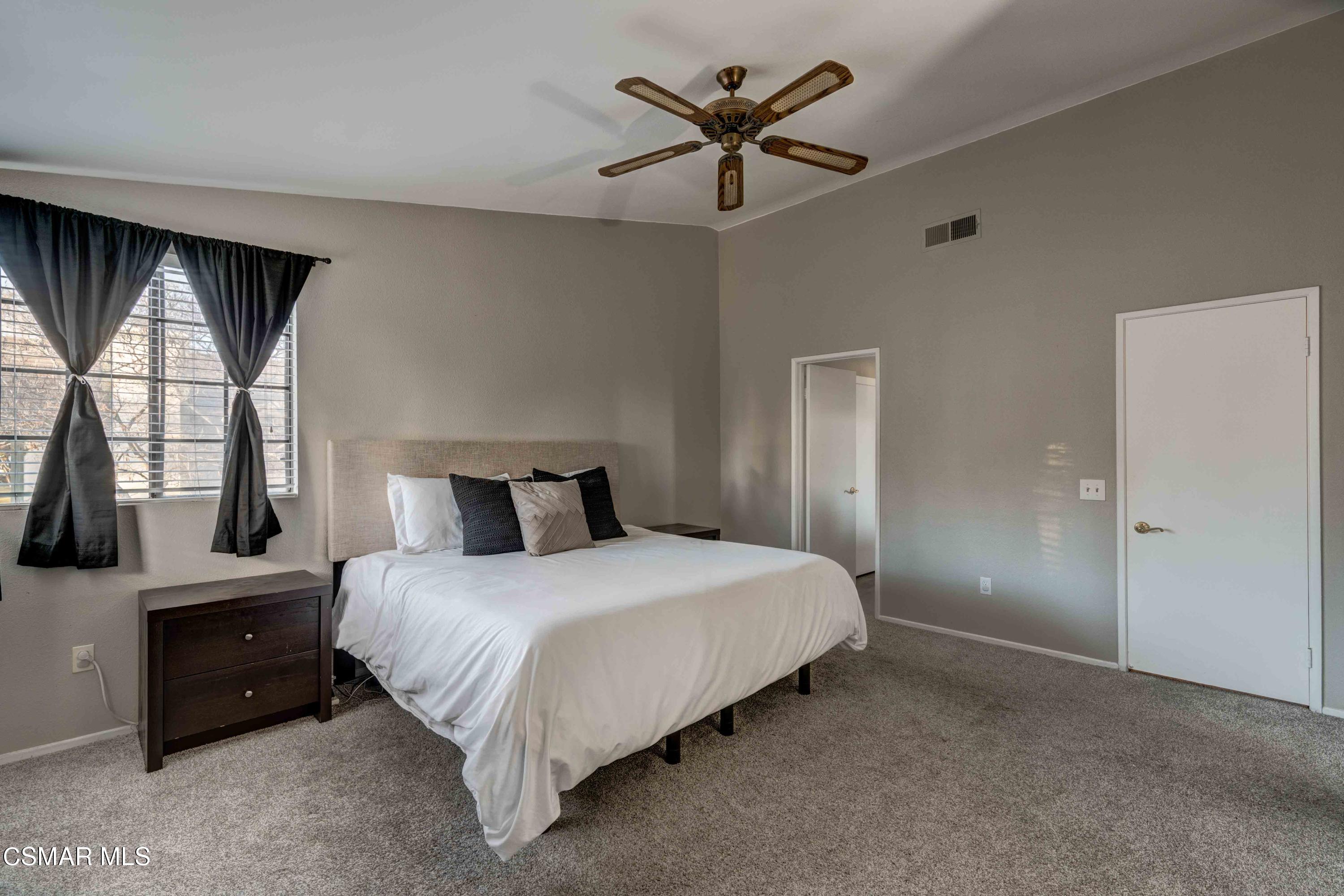 3620 Olds Road Oxnard, CA 93033 - Photo 14 of 34 a bedroom with a large bed and a chandelier fan