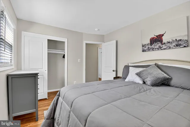 a bedroom with a large bed and a window