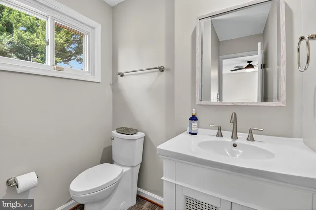 a white toilet sitting next to a bathroom sink