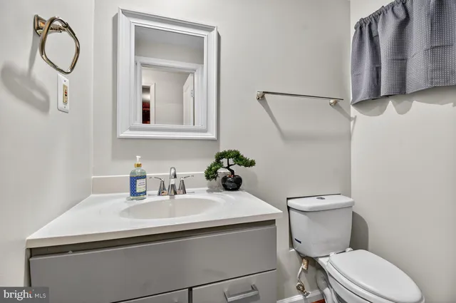 a bathroom with a toilet sink and mirror