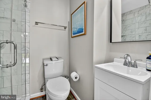 a bathroom with a toilet sink and shower
