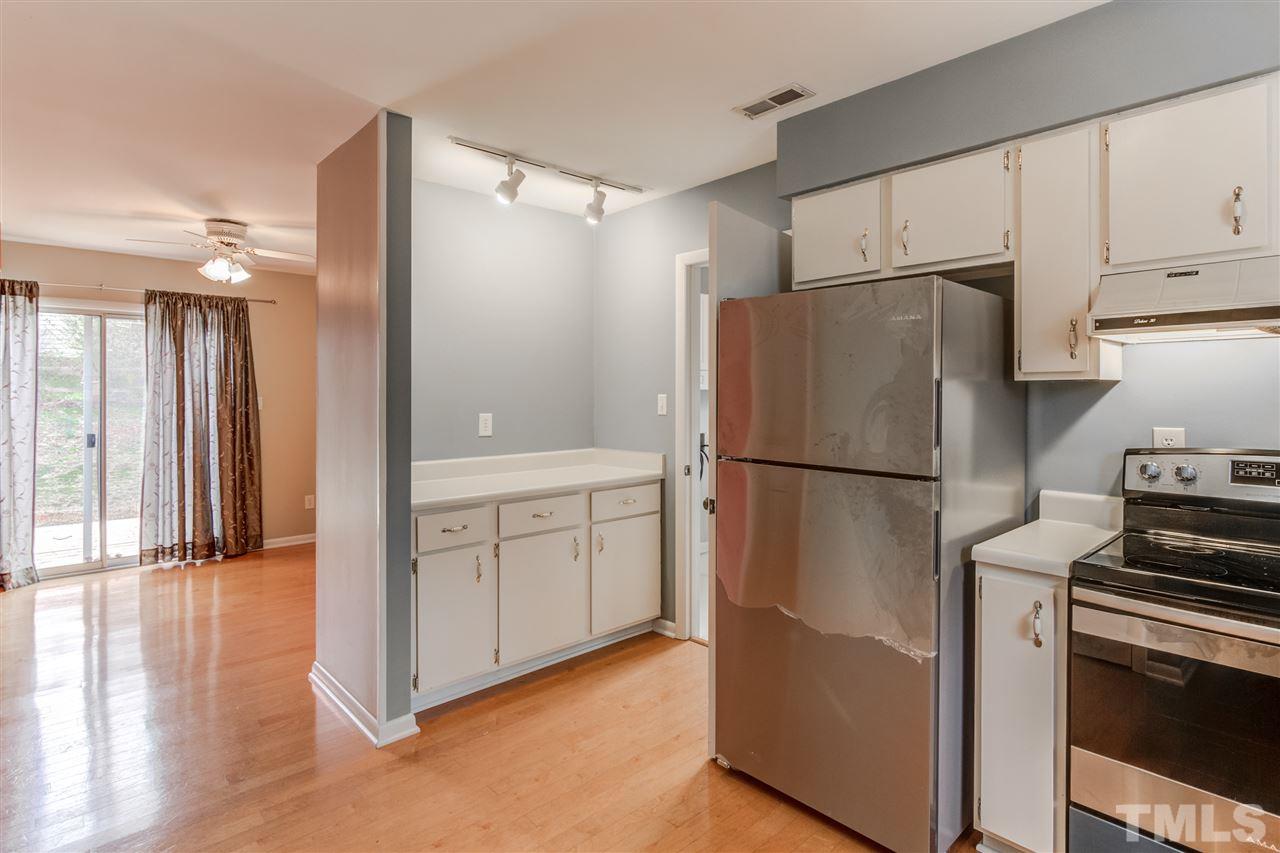 5705 Calorie Court Raleigh, NC 27612 - Photo 11 of 24 a kitchen with cabinets and stainless steel appliances
