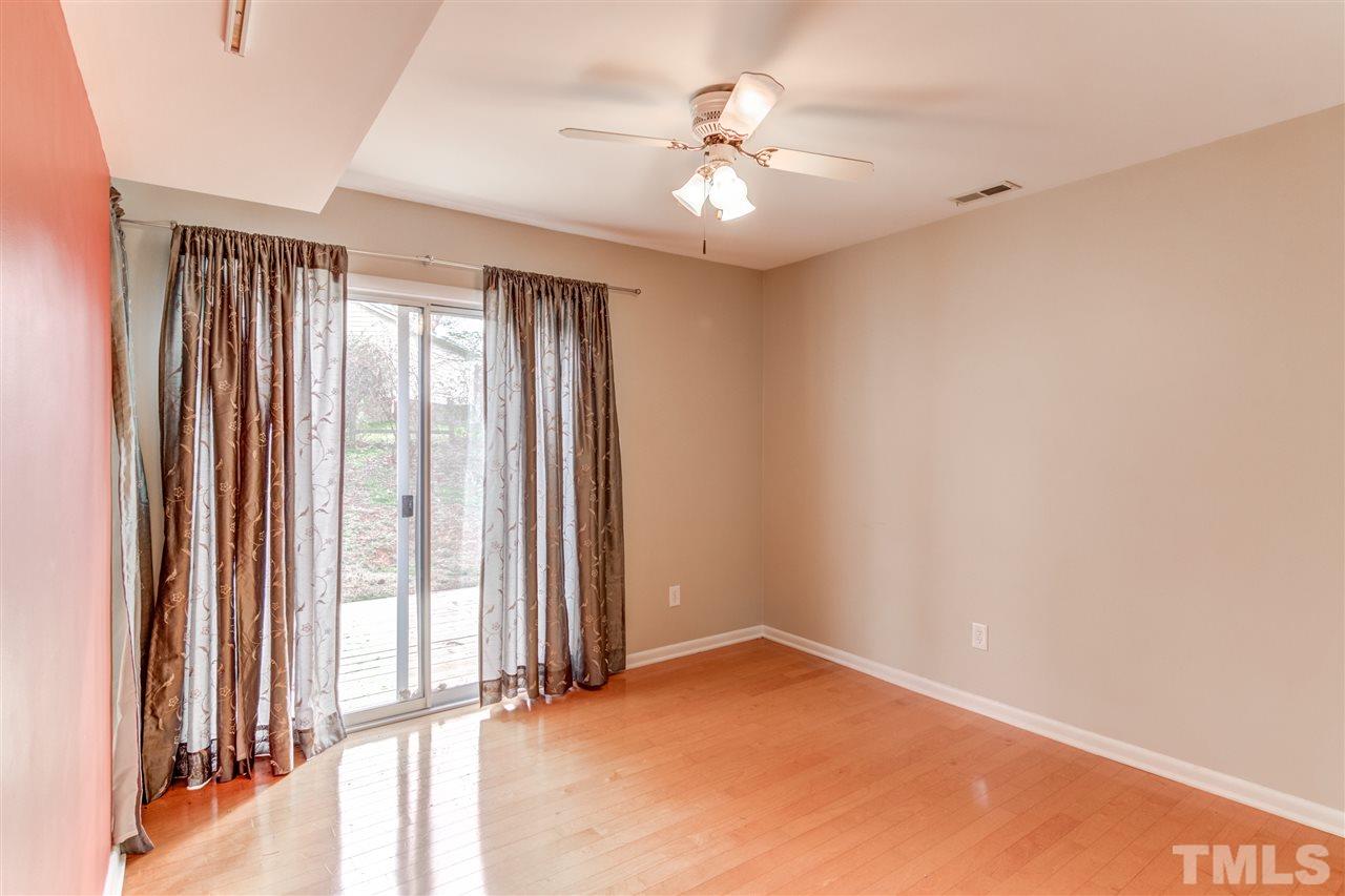 5705 Calorie Court Raleigh, NC 27612 - Photo 12 of 24 an empty room with windows and chandelier fan