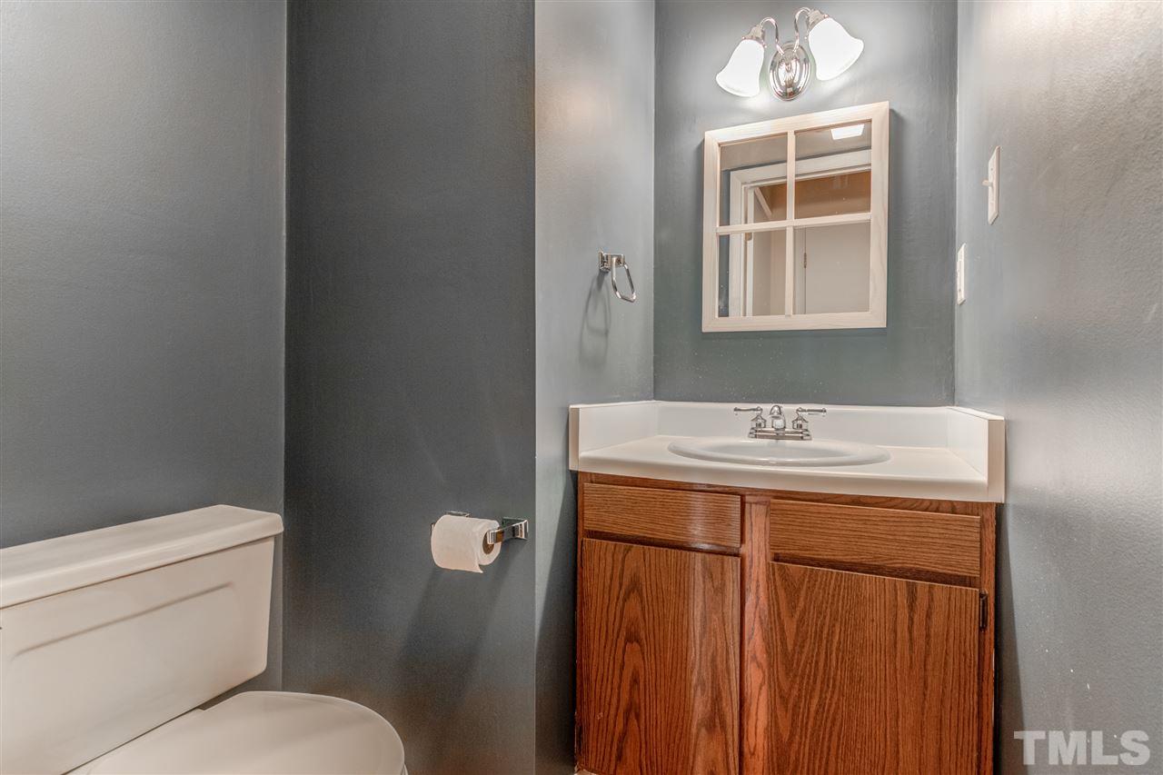 5705 Calorie Court Raleigh, NC 27612 - Photo 13 of 24 a bathroom with a sink toilet and mirror