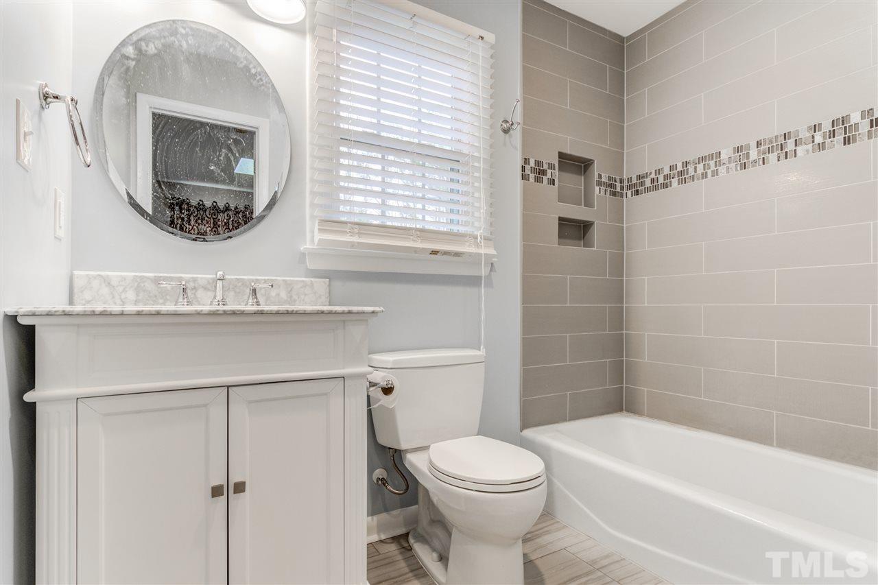 5705 Calorie Court Raleigh, NC 27612 - Photo 17 of 24 a bathroom with a toilet a sink and mirror