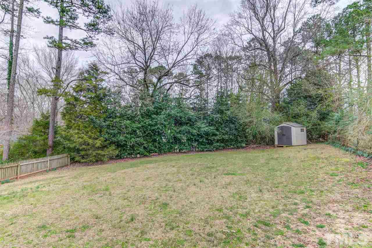 5705 Calorie Court Raleigh, NC 27612 - Photo 23 of 24 a view of a field with trees in front of the house