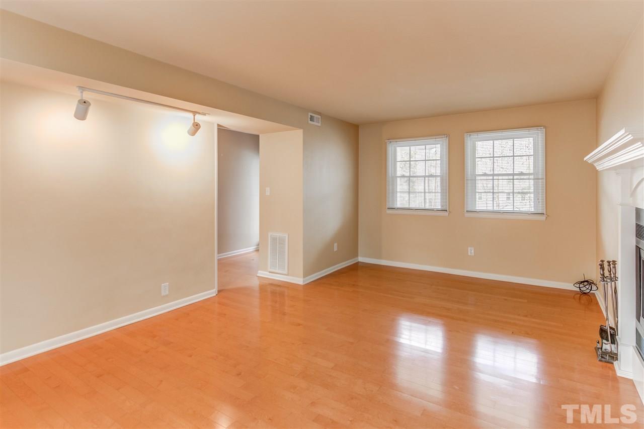 5705 Calorie Court Raleigh, NC 27612 - Photo 4 of 24 an empty room with wooden floor and windows