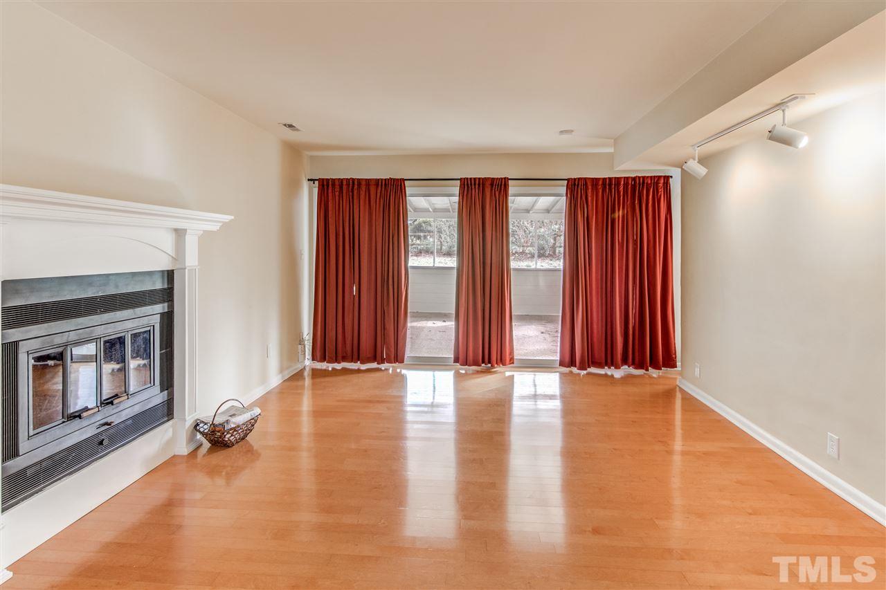 5705 Calorie Court Raleigh, NC 27612 - Photo 6 of 24 a view of an empty room with window and wooden floor