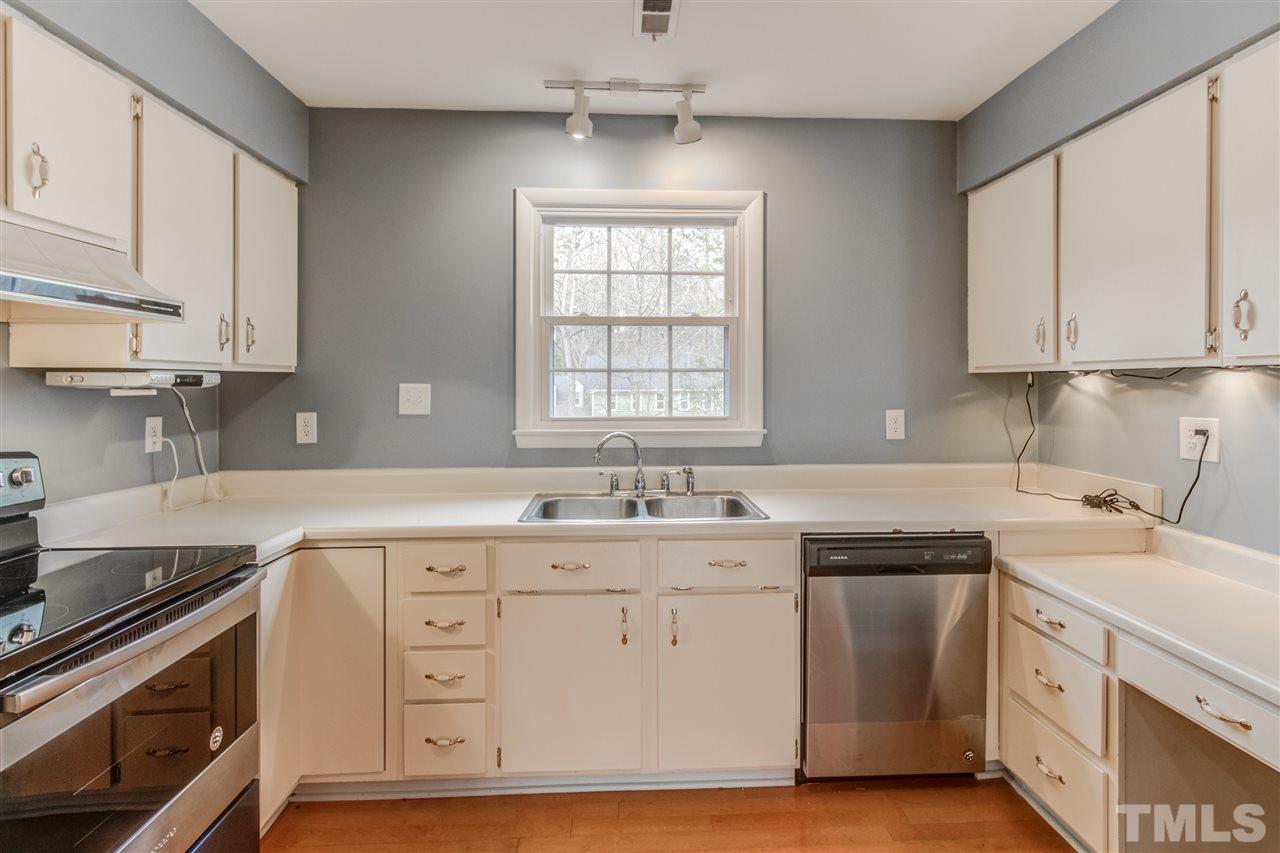 5705 Calorie Court Raleigh, NC 27612 - Photo 8 of 24 a kitchen with a sink stove and cabinets