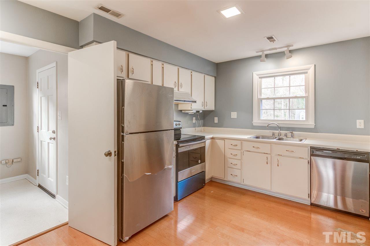 5705 Calorie Court Raleigh, NC 27612 - Photo 10 of 24 a kitchen with stainless steel appliances a refrigerator sink and cabinets