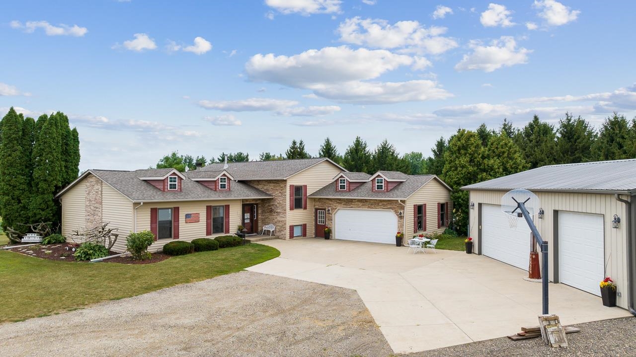 10388 Telegraph Road Winnebago, IL 61088 - Photo 1 of 48 a front view of a house with a garden and yard