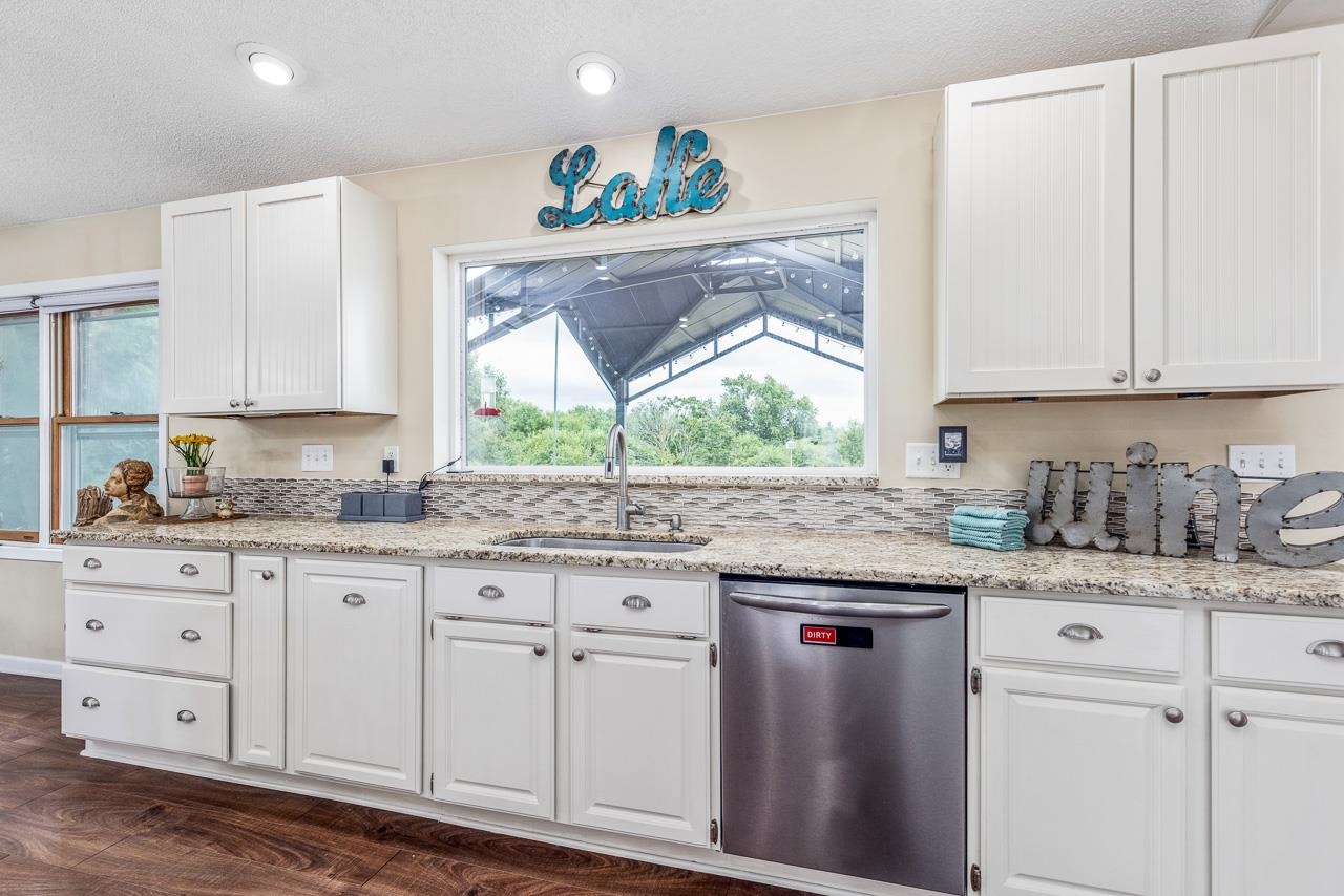 10388 Telegraph Road Winnebago, IL 61088 - Photo 13 of 48 a kitchen with granite countertop a sink and cabinets