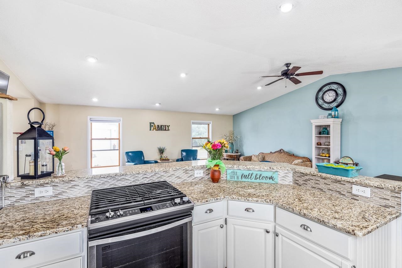 10388 Telegraph Road Winnebago, IL 61088 - Photo 14 of 48 a kitchen with granite countertop a stove and cabinets