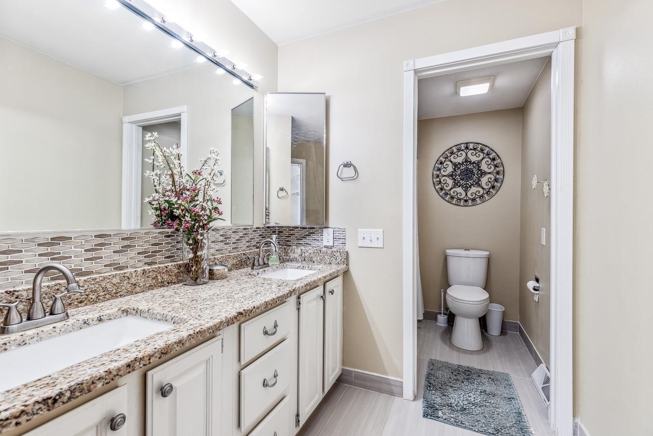 10388 Telegraph Road Winnebago, IL 61088 - Photo 18 of 48 a bathroom with a granite countertop sink mirror and toilet