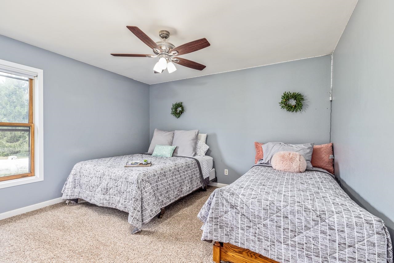 10388 Telegraph Road Winnebago, IL 61088 - Photo 21 of 48 a bedroom with two beds and a window