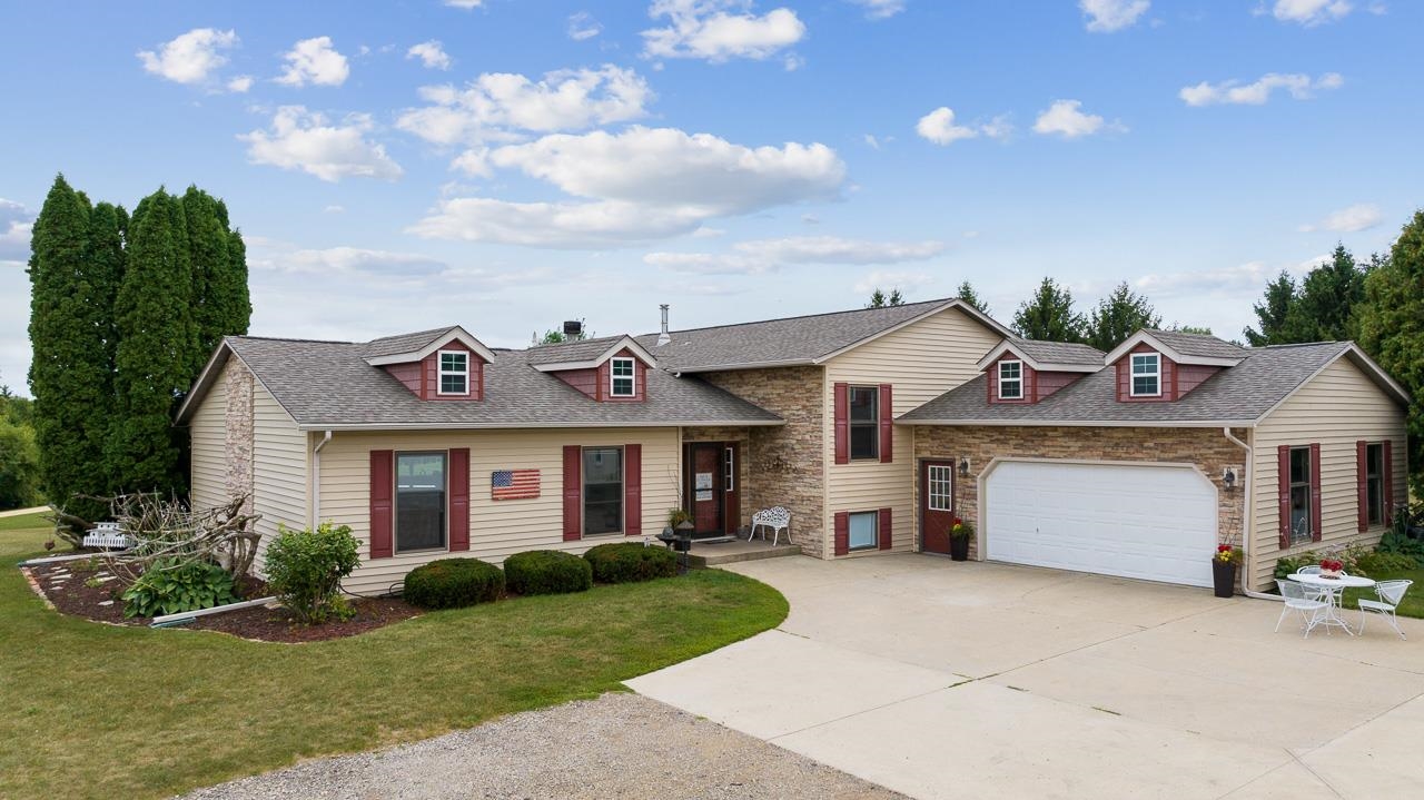 10388 Telegraph Road Winnebago, IL 61088 - Photo 3 of 48 a front view of a house with a yard and potted plants