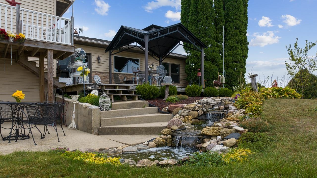 10388 Telegraph Road Winnebago, IL 61088 - Photo 37 of 48 a front view of a house with a garden