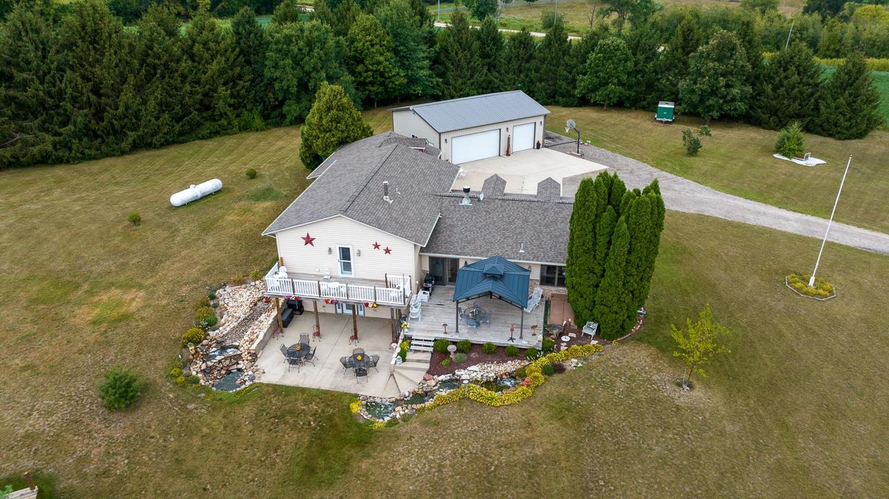 10388 Telegraph Road Winnebago, IL 61088 - Photo 43 of 48 an aerial view of a house with a garden and swimming pool