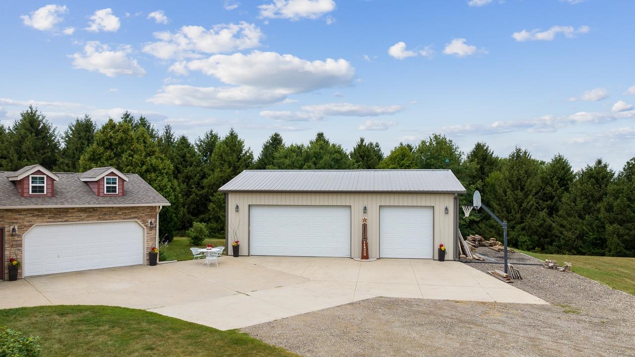 10388 Telegraph Road Winnebago, IL 61088 - Photo 45 of 48 a front view of a house with a yard and garage