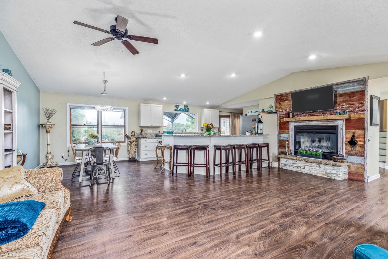 10388 Telegraph Road Winnebago, IL 61088 - Photo 8 of 48 a living room with furniture a fireplace and a flat screen tv