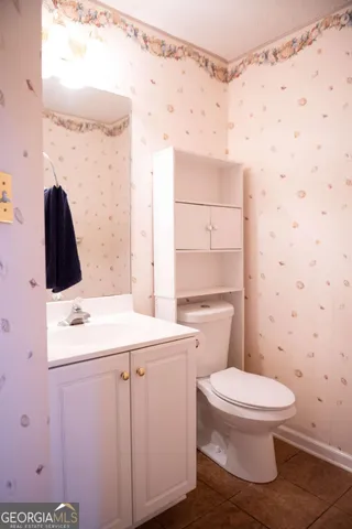 a bathroom with a sink toilet vanity and shower