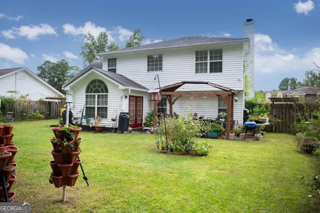 a front view of a house with a garden and porch