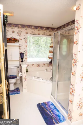 a view of bathroom with bathtub and shower