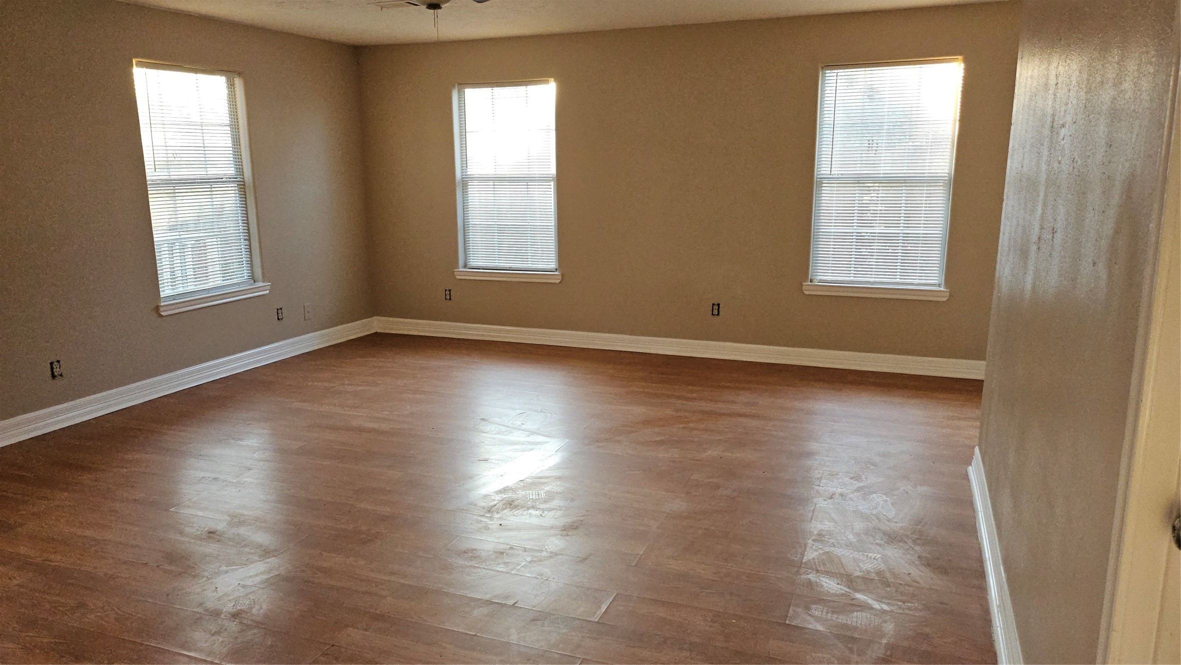 4714 Sharon Street Houston, TX 77020 - Photo 3 of 14 an empty room with wooden floor and windows