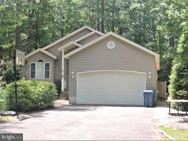 77 Sandyhook Road Ocean Pines, MD 21811 - Photo 1 of 31 a front view of a house with a yard and garage