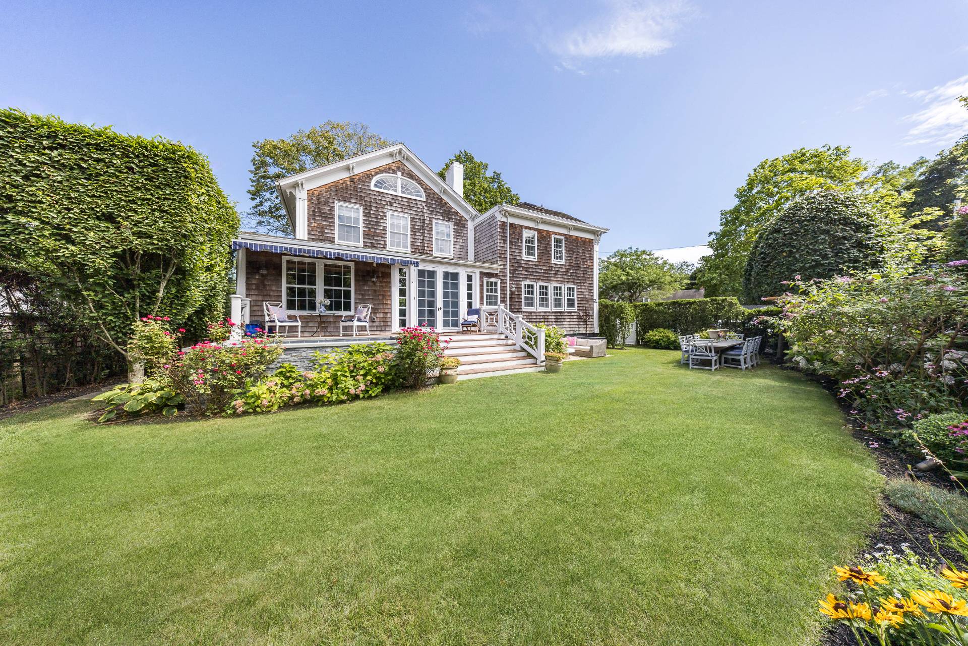 a front view of a house with a garden